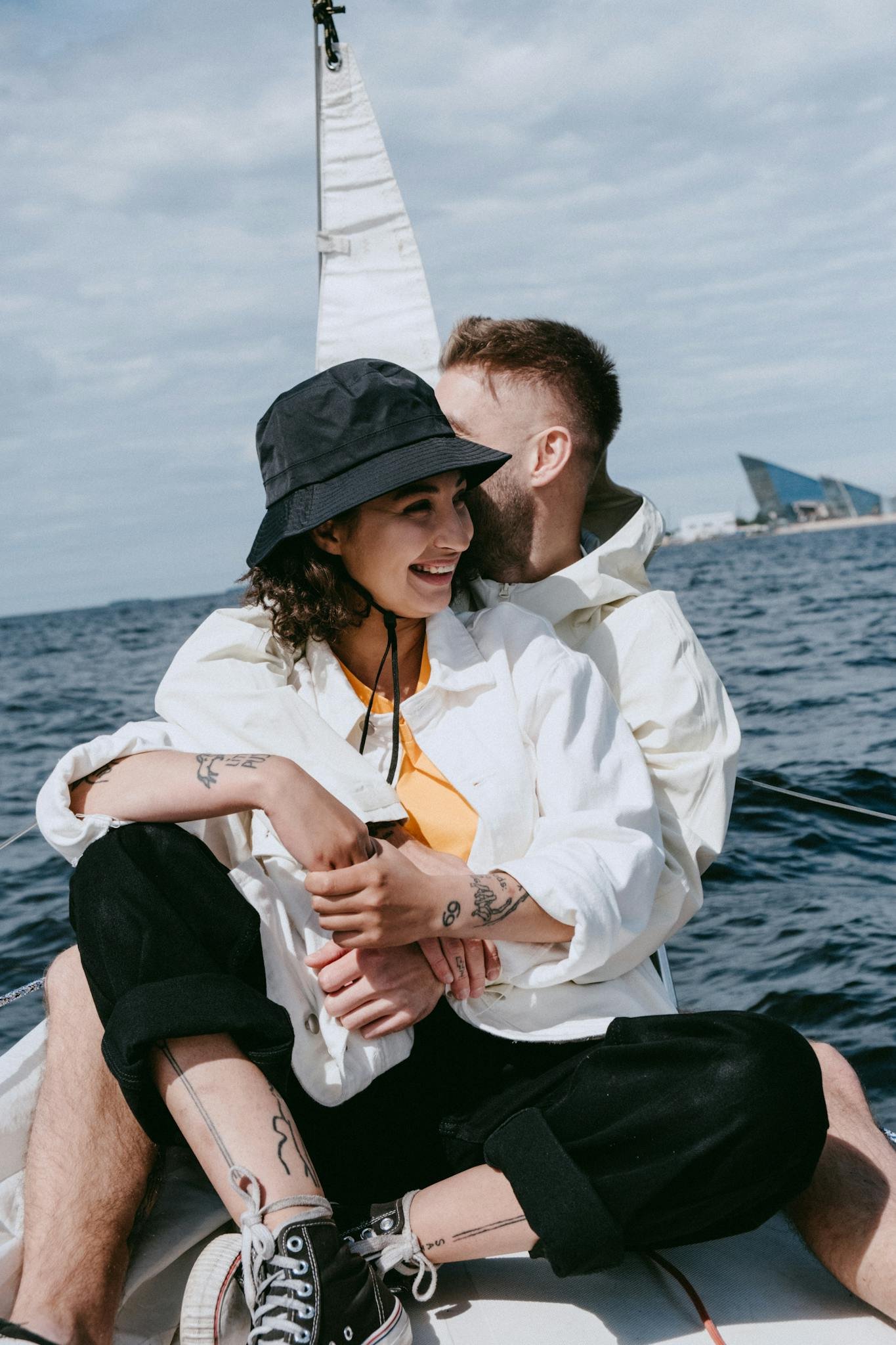 Man in White Dress Shirt and Black Pants Sitting on Boat