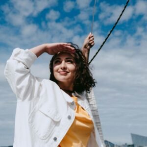 Woman in White Coat Holding Her Hair